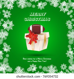 Gift packaging with a ball for American football and gold ribbons and a red bow on the background of snowflakes. Festive greeting card for Christmas and New Year