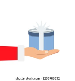Gift from Santa Claus. Santa Claus holding white gift box in hand. Vector illustration flat design. Merry Christmas and Happy New Year c