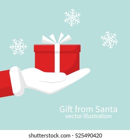 Gift from Santa Claus. Santa Claus holding white gift box in hand. Vector illustration flat design. Merry Christmas and Happy New Year on a snowy background.