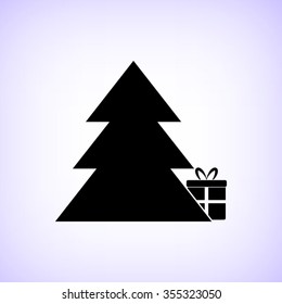 Gift under christmas tree -  black vector icon