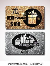 Gift voucher on the shiny gold and silver backgrounds