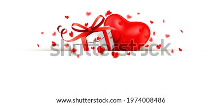 Giftbox with bow, heart and heart shaped confetti behind a banner