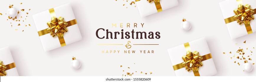 Gifts box on background. Merry Christmas and Happy New Year. Xmas white gifts boxes, pattern of presents, glass balls, glitter gold confetti. flat lay top view. Horizontal  poster, headers for website