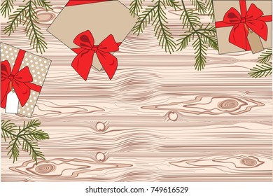 gifts on a wooden background with a red ribbon with spruce branches. view from above