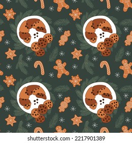 Gingerbread and candied cupcake Christmas holiday seamless pattern on emerald background.