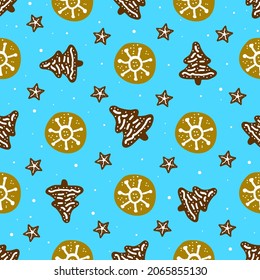 Gingerbread Christmas trees and gingerbread on a blue background. The pattern is New Year and Christmas. For a family holiday, wallpaper, background, wrapping paper, fabric.