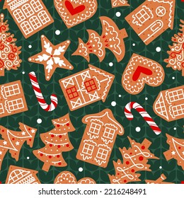 Gingerbread, decorated with icing, lie on a green knitted sweater. Christmas seamless pattern. Traditional cookies. Houses, candy cane, snowflakes and hearts. For wallpaper, fabric, wrapping.