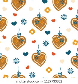 Gingerbread heart seamless pattern for Oktoberfest on a blue and white plaid background. Lebkuchenherz. Vector illustration. Great for backgrounds, wrapping, fabric, and packaging.