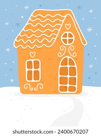 Gingerbread house. Homemade christmas cookie. Cute house with white sugar glaze. Blue background. Christmas card.  