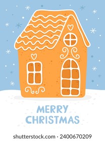 Gingerbread house. Homemade christmas cookie. Cute house with white sugar glaze. Inscription "Merry Christmas". Blue background. Christmas card.  