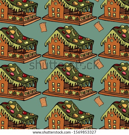 Gingerbread house and a piece of bread, on a dark background.