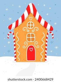 Gingerbread house with red white striped christmas candies. Cute house with red roof and white sugar glaze. Blue background. Christmas card.  