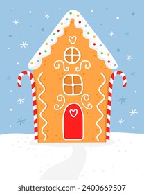 Gingerbread house with red white striped christmas candies. Cute house with white roof, red door and white sugar glaze. Blue background. Christmas card.  