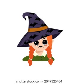 Girl with angry emotions, grumpy face, furious eyes in a pointed witch hat with bats. Head of cute child with furious expression in carnival costume for the holiday or Halloween party