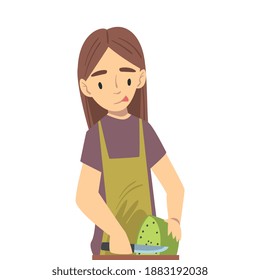 Girl in Apron Cooking in the Kitchen, Teenage Girl Cutting Vegetables Cartoon Style Vector Illustration
