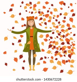 girl in autumn clothes standing under leaf fall