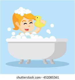 girl in bathtub holding a toy duck