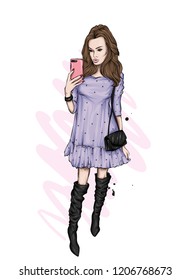 A girl in a beautiful dress makes selfie with a smartphone. Fashion, style, clothing and accessories. Vector illustration. Stylish girl. Beautiful dress, boots and bag.