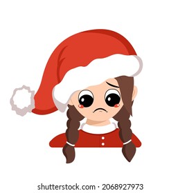 Girl with big eyes and sad emotions, depressed face, down eyes in red Santa hat. Cute child with melancholy expression in carnival costume for holiday, New Year and Christmas. Head of adorable kid