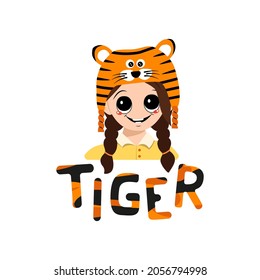 Girl with big eyes and wide smile in tiger hat with lettering. Cute kid with happy face in festive costume for New Year, Christmas and holiday. Head of adorable child with smile emotions