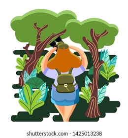 Girl with binoculars in the forest during the holidays.