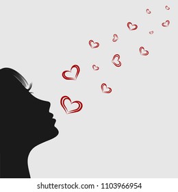 Girl blowing on hearts. Silhouette.