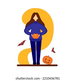 Girl in blue clothes holding a pumpkin