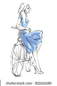 Girl in a blue dress on bicycle