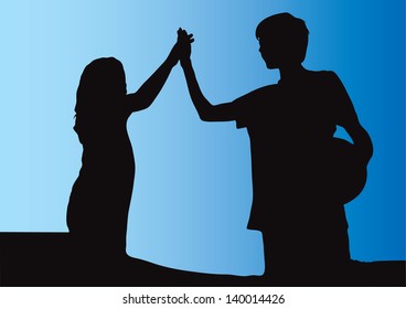 Girl and boy holding hands and making high five gesture after playing soccer football