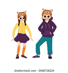 Girl and boy in orange hat of tiger. Children carnival party. Kids in costumes of animal for New year, Christmas or holiday