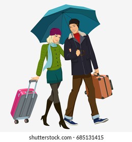 Girl and boy under the umbrella. Beautiful couple with suitcases and an umbrella