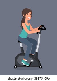 Girl brunette goes in for sports. Girl on the exercise bike.