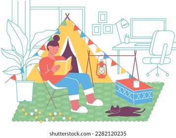 A girl is camping with a tent in her room. She is sitting in a camping chair and reading a book. The cat is sleeping on the rug. There is a desk in the background.