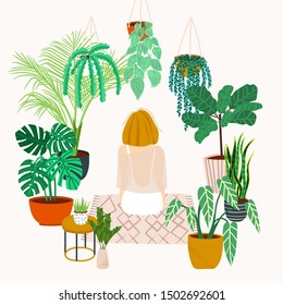 Girl caring for plants. Greenhouse, plants growing in pots. Crazy plant lady. Watering a home garden. Girl meditates on a rug in the interior with potted plants and flowers. Girl resting at home