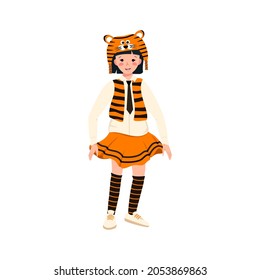 Girl in carnival costume and tiger hat. Festive clothing for theatre, new year, Christmas and holiday. Child is dancing with joyful face and happy emotions