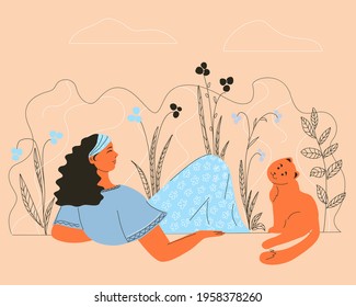 Girl with a cat resting on the grass