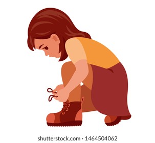 girl crouched and tying the laces on the shoes