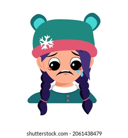 Girl with crying and tears emotion, sad face, depressive eyes and blue hair in bear hat with snowflake. Cute child with melancholy expression in winter headdress. Head of adorable kid with emotions