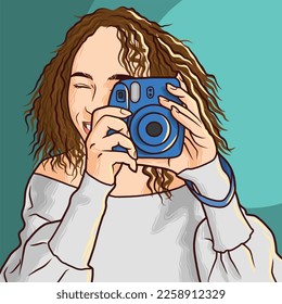 a girl with curly hair taking photo with blue camera