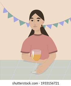 Girl with dark hair at a party with a drink. Decor from multi-colored flags. 