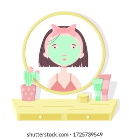 The girl with dark hair in a pink T-shirt put a beauty mask on her face and looks in the mirror