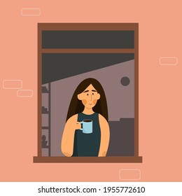 Girl with dark hair in the window isolated at home holds a cup with a drink. 