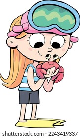 girl diver holds a small crab in her hand
