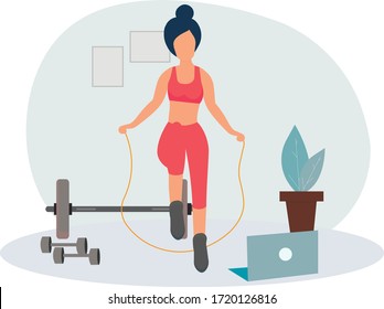 The girl does exercises, online training at home on a skipping rope . Stay at home. Sports online, fitness training. Healthy lifestyle. Keep yourself in shape. Quarantine isolation of the coronavirus.