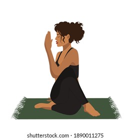 The girl does yoga online in the lotus position on the mat