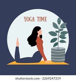 The girl does yoga. A woman is doing physical exercises. A girl in a T-shirt and leggings.