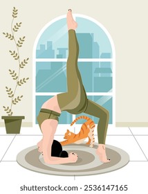 A girl is doing yoga and years green clothes with a cute orange cat