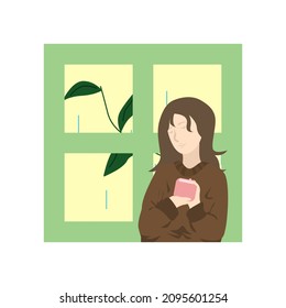 Una chica bebe té cerca de la ventana