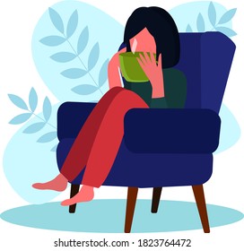 Girl drinks tea from a mug sitting in a chair