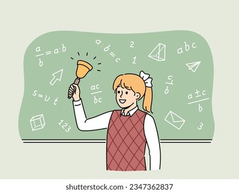 Girl elementary school student with bell stands near chalkboard with mathematical formulas and examples. Happy schoolgirl with bow on blond hair makes call, for concept back to school